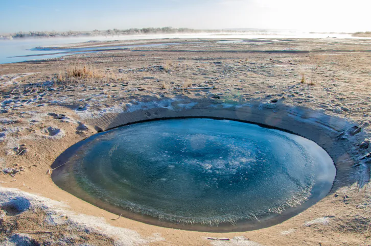 A file photo of a meteorite crater filled with water on Earth. (Thinkstock)