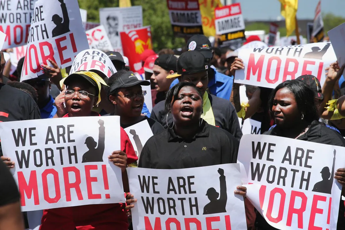 Fast food workers and activists demonstrate outside the McDonald's corporate campus Oak Brook, Illinois, in this file photo. The demonstrators were calling on McDonald's to pay a minimum wage of $15-per-hour, however, the minimum wage has many bad unintended consequences. (Scott Olson/Getty Images)