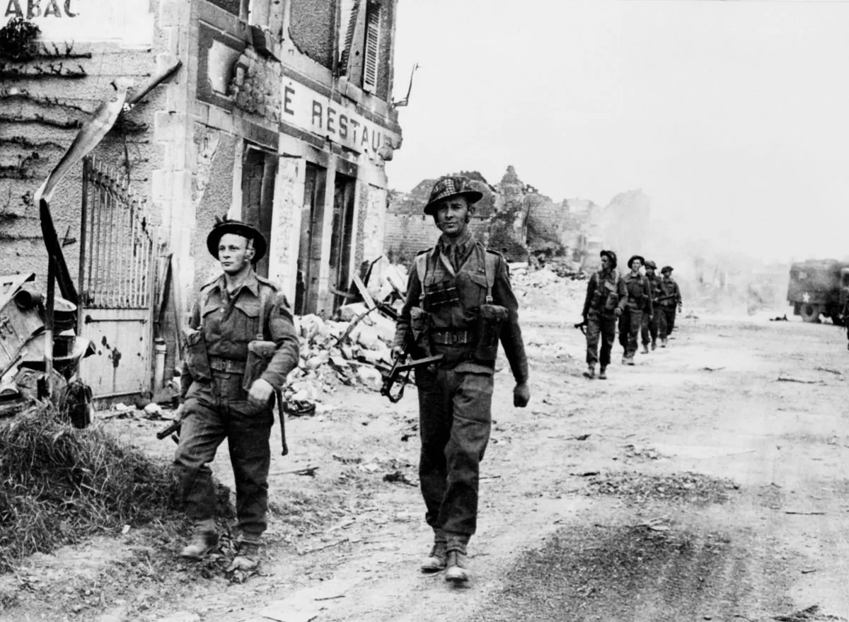Allied soldiers cross 08 June 1944 the village of Douet, after the town of Bayeux fell, two days after the allied troops landed on Normandy beaches (north-west of France), to come as reinforcements during the historic D-Day, 06 June 1944, during WWII. (STF/AFP/Getty Images)