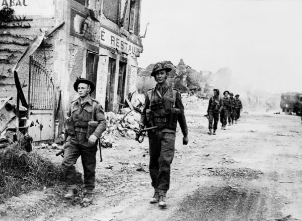 Allied soldiers cross 08 June 1944 the village of Douet, after the town of Bayeux fell, two days after the allied troops landed on Normandy beaches (north-west of France), to come as reinforcements during the historic D-Day, 06 June 1944, during WWII. (STF/AFP/Getty Images)