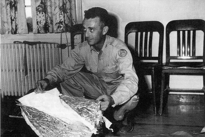 Major Jesse Marcel holds up pieces of a crashed weather balloon found 75 miles northwest of Roswell, N.M., in June 1947. Purported leaked documents, known as the Majestic 12 documents, claim that the weather balloon was a cover story for an extraterrestrial crash. If the documents are genuine, then a highly secret agency known as the Majestic 12 may have overseen the cleanup and cover-up of said crash. (United States Air Force/AFP/Getty Images)
