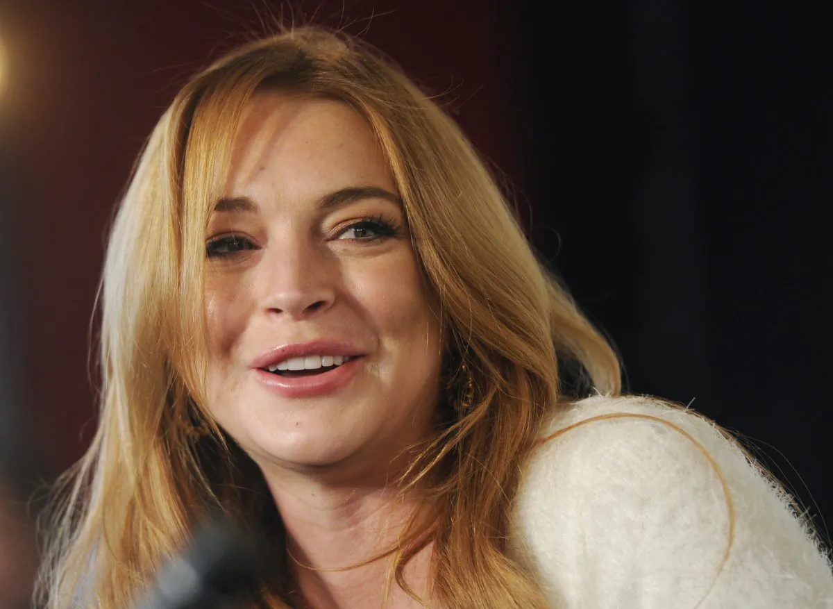 In this Jan. 20, 2014, photo actress Lindsay Lohan addresses reporters during a news conference at the 2014 Sundance Film Festival in Park City, Utah. Linsday Lohan is heading for the London stage - in a play about the hysteria of Hollywood. Producers announced Thursday, June 26, 2014 that Lohan will make her professional stage debut in September in David Mamet's satirical drama "Speed-the-Plow." The "Mean Girls" and “Freaky Friday” star, who has had well-documented troubles with alcohol, drugs and the law, will take the relatively small but complex role of an ambitious secretary in Mamet's drama about two Hollywood producers trying to close a major deal. (Chris Pizzello/Invision/AP Photo)