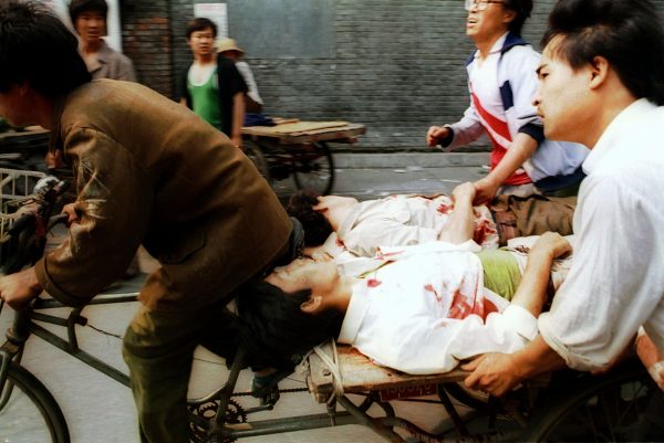 In this June 4, 1989, photo a rickshaw driver peddles wounded people, with the help of bystanders, to a nearby hospital in Beijing after they were injured during clashes with Chinese soldiers in Tiananmen Square. The crackdown ended a period of relative political openness, led to the downfall of Communist Party leader Zhao Ziyang and plunged Beijing into diplomatic isolation that lasted until the late 1990s. (AP Photo/Liu Heung Shing)