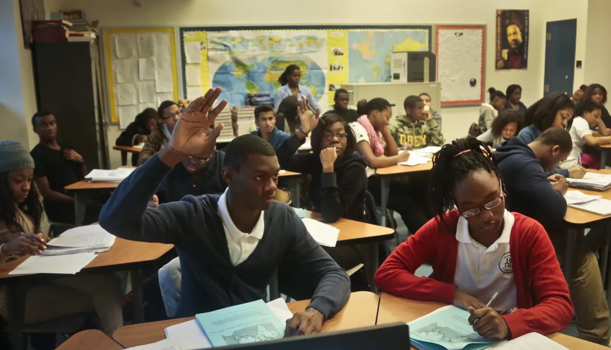 Students raise hands during a Global Studies class of 10th- and 11th-graders at Bedford Academy High School, Brooklyn, Dec. 3. (Bebeto Matthews/AP)