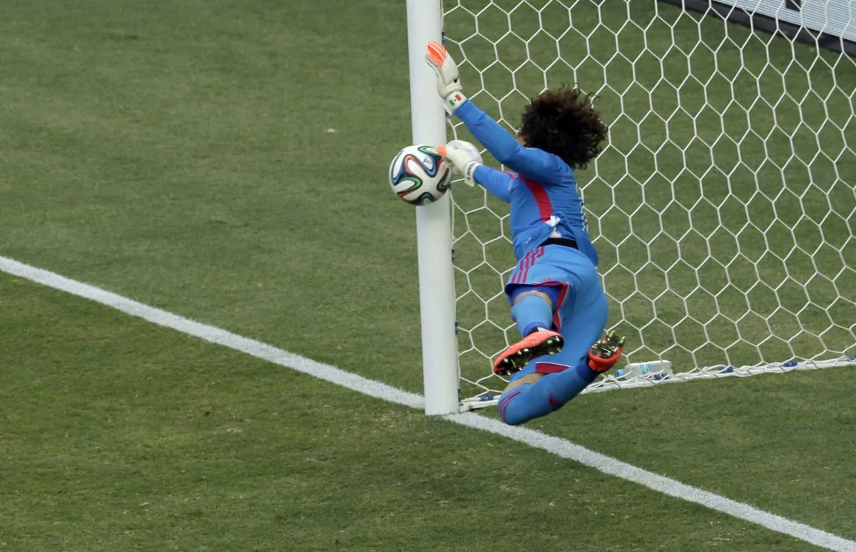 Mexico's goalkeeper Guillermo Ochoa makes a save during the group A World Cup soccer match between Brazil and Mexico at the Arena Castelao in Fortaleza, Brazil, Tuesday, June 17, 2014.  (AP Photo/Themba Hadebe)