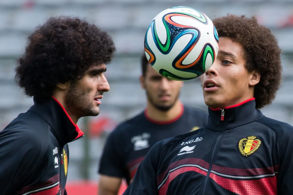 Belgium's national soccer team players Axel Witsel, right, and Marouane Fellaini practice during their last training in Belgium before leaving for Brazil at the King Baudouin stadium in Brussels, Sunday June 8, 2014. Fellaini scored in the first World Cup game on Tuesday. (AP Photo/Geert Vanden Wijngaert)