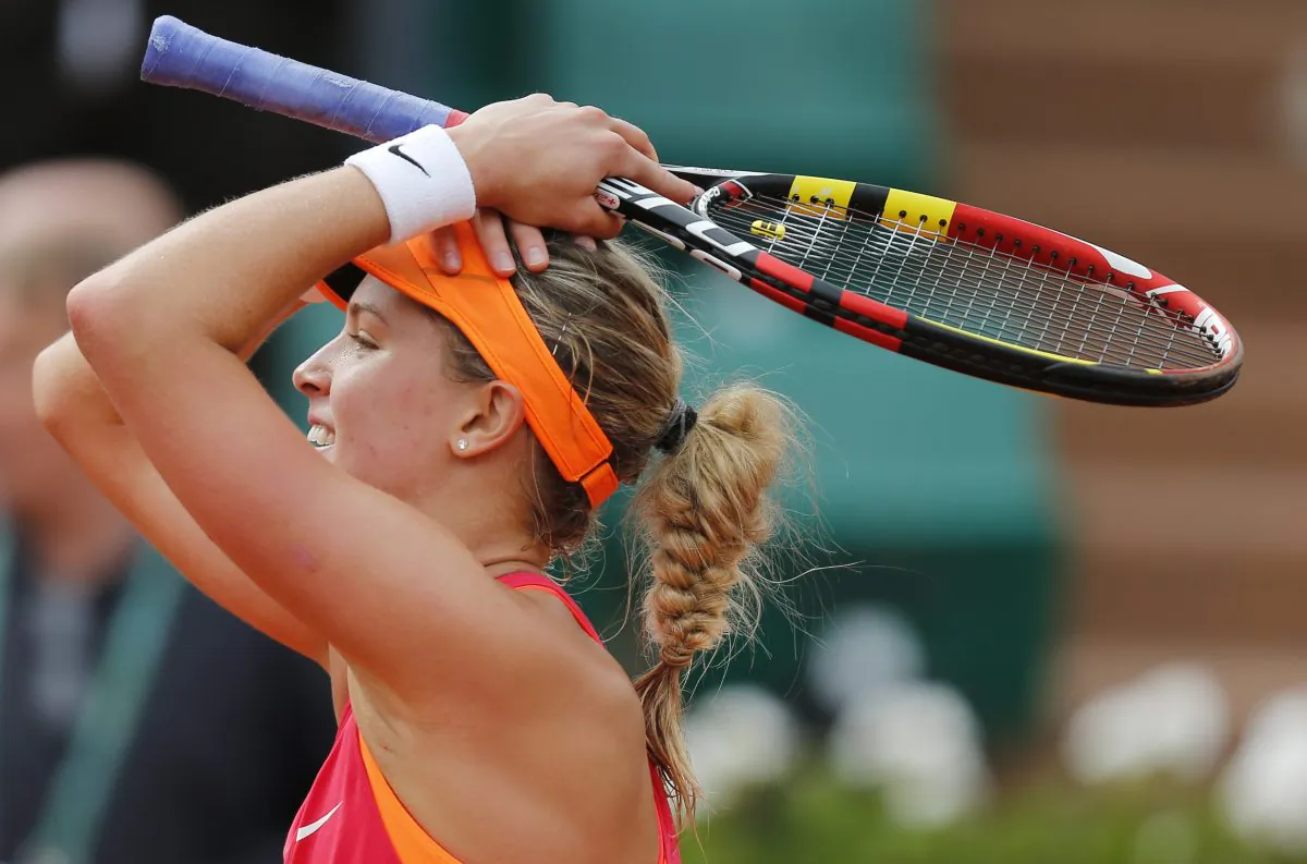 Canada's Eugenie Bouchard smiles after defeating Spain's Carla Suarez Navarro during their quarterfinal match of  the French Open tennis tournament at the Roland Garros stadium, in Paris, France, Tuesday, June 3, 2014. Bouchard won 7-6, 2-6, 7-5.  (AP Photo/David Vincent)