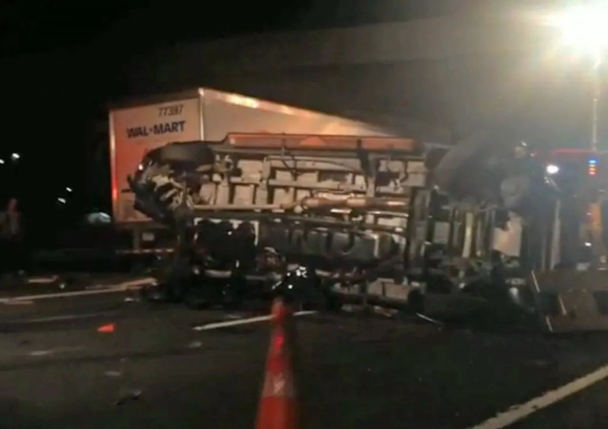 In this image from video the limousine bus carrying Tracy Morgan and six other people lies on its side early Saturday morning June 7, 2014 on the New Jersey Turnpike. (AP Photo/Will Vaultz Photography)