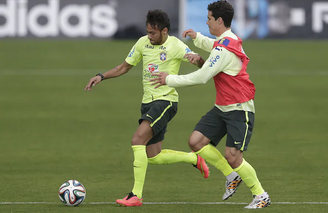 Brazil's Neymar, left, and Hernanes practice during a training session of Brazilian national soccer team, at the Granja Comary training center in Teresopolis, Brazil, Monday, June 9, 2014. Brazil play in group A of the 2014 soccer World Cup. (AP Photo/Andre Penner)