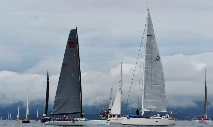 Boats cruising around the Committee Boat waiting for the start of Race-2 of the Hebe Haven Quest Yachting Typhoon Series on Sunday June 22, 2014. After waiting for more than 2-hours, lack of wind forced the proceedings to be abandoned. (Bill Cox/Epoch Times)