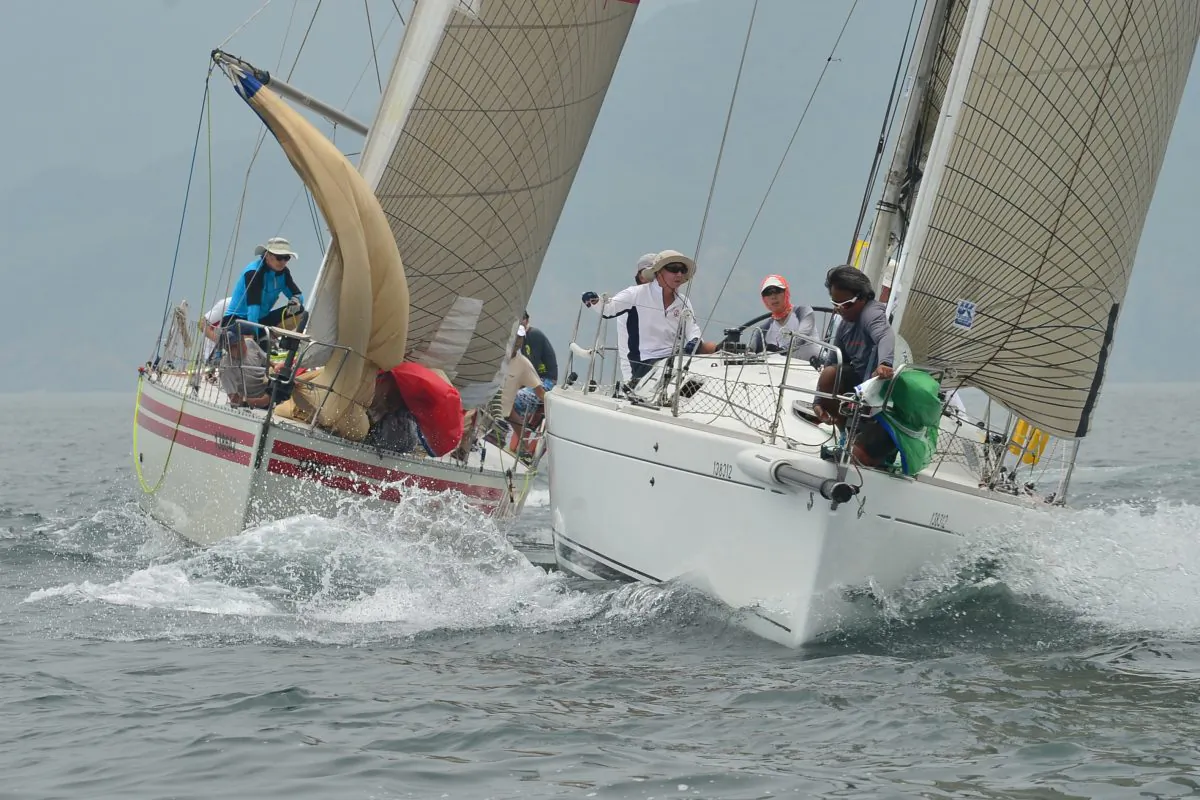 ‘Intrigue Plus’ and ‘Calamansi’ have a close encounter while rounding the Steep Island Mark during the first race of the Hebe Haven Quest Yachting Typhoon Series on Sunday June 8. (Bill Cox/Epoch Times)