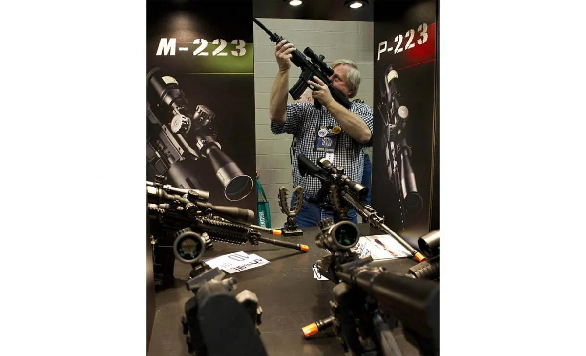 A gun enthusiast checks out a scope at the 143rd NRA Annual Meetings and Exhibits in Indianapolis, Indiana on April 26, 2014. (Karen Bleier/AFP/Getty Images)