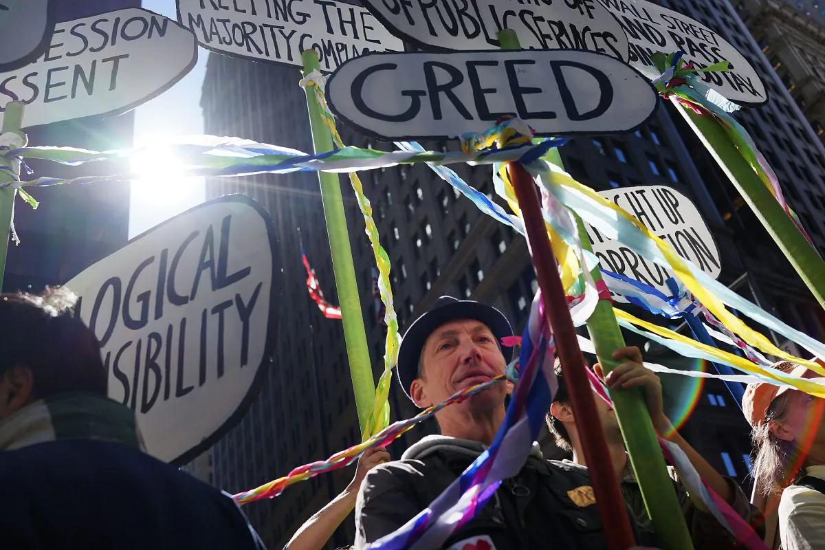 Protesters affiliated with Occupy Wall Street, taking aim at inequality and financial greed, demonstrate in New York on Sept. 17, 2013. (Spencer Platt/Getty Images)