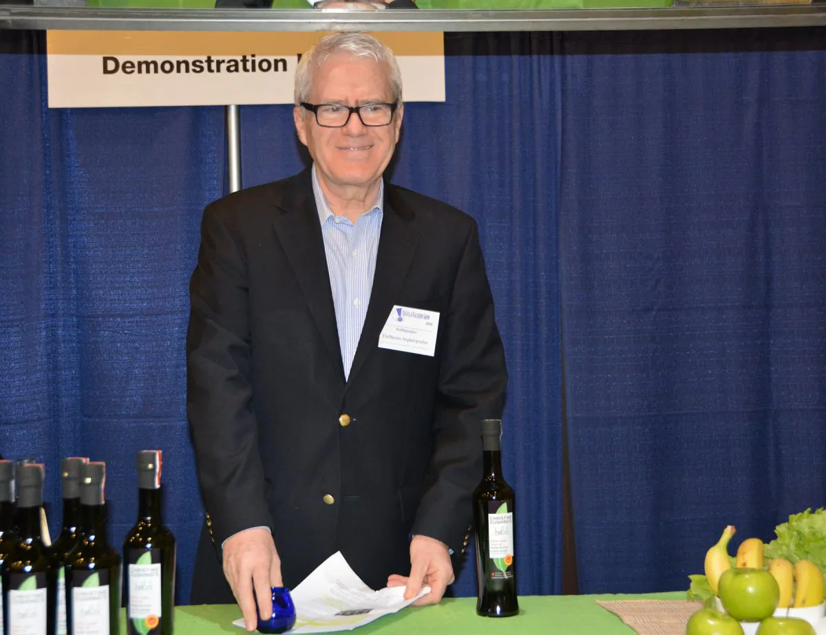 Greek Ambassador Eleftherios Anghelopoulos talks about Canadian celebrity chef Christine Cushing's olive oil at this year’s Ottawa Travel and Vacation Show. (Athanasia Papatriantafyllou) 