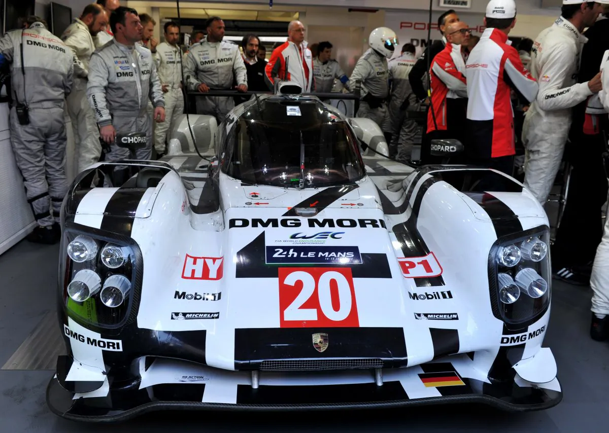 Mark Webber and his crew look at the expired #20 Porsche 919 Hybrid in the paddock during the 82nd edition of the Le Mans 24-hours, on June 15, 2014 in Le Mans, western France. (Guillaume Souvant/AFP/Getty Images)