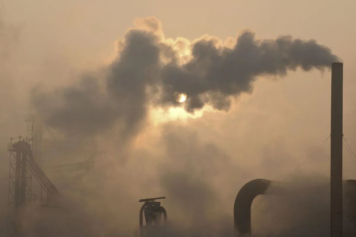 Smoke is emitted from chimneys of a cement plant in Binzhou City, Shandong Province, China, on Jan. 17, 2013. (AP Photo)