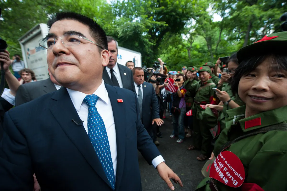 Chen Guangbiao, a Chinese businessman, stands outside the Loeb Boathouse with his security entourage on June 25. Chen organized a confusing event, ostensibly for homeless New Yorkers, in which he vilified a Chinese spiritual practice. (Dai Bing/Epoch Times)