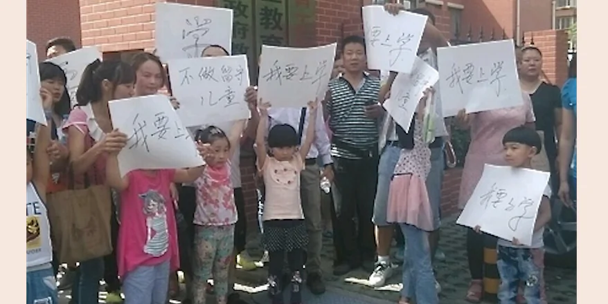Migrant worker parents and children protest in front of Beijing's suburban Chaoyang district education department on May 25, 2014. Their children have been barred from attending school in Beijing because they do not have the needed residency papers. (Photograph supplied)