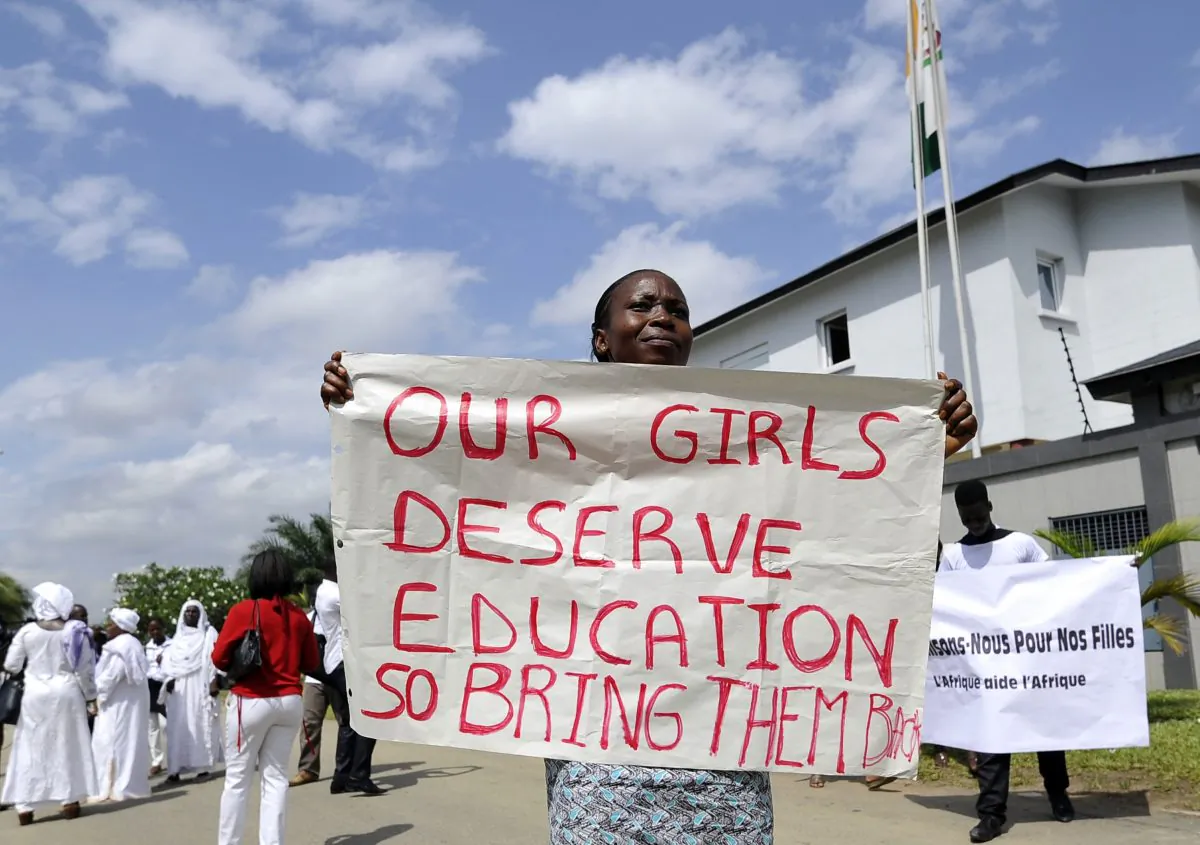 A woman holds a sign to call for the release of more than 200 schoolgirls kidnapped by Boko Haram militants on May 19, 2014 during a sit-in orchestrated by human rights organizations in Abidjan. (Sia Kambou/AFP/Getty Images)
