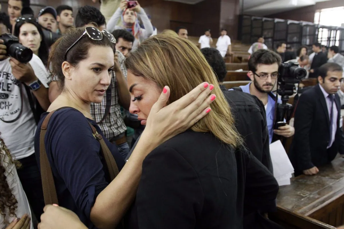 Mohamed Fahmy’s fiance is consoled by a friend following the verdicts in the sentencing on hearing for three Al-Jazeera journalists, including Fahmy, in a courtroom in Cairo on June 23. The journalists were each sentenced to seven years on terrorism charges. (AP Photo/Ahmed Abd El Latif, El Shorouk Newspaper)