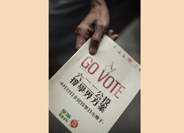 An activist distributes leaflets asking residents of Hong Kong to cast ballots for a June 22 referendum concerning universal suffrage, on June 12, 2014. A white paper on Hong Kong issued by the Chinese regime appears to have aroused people's interest in the referendum while simultaneously alienating the people of Taiwan. (Philippe Lopez/AFP/Getty Images)