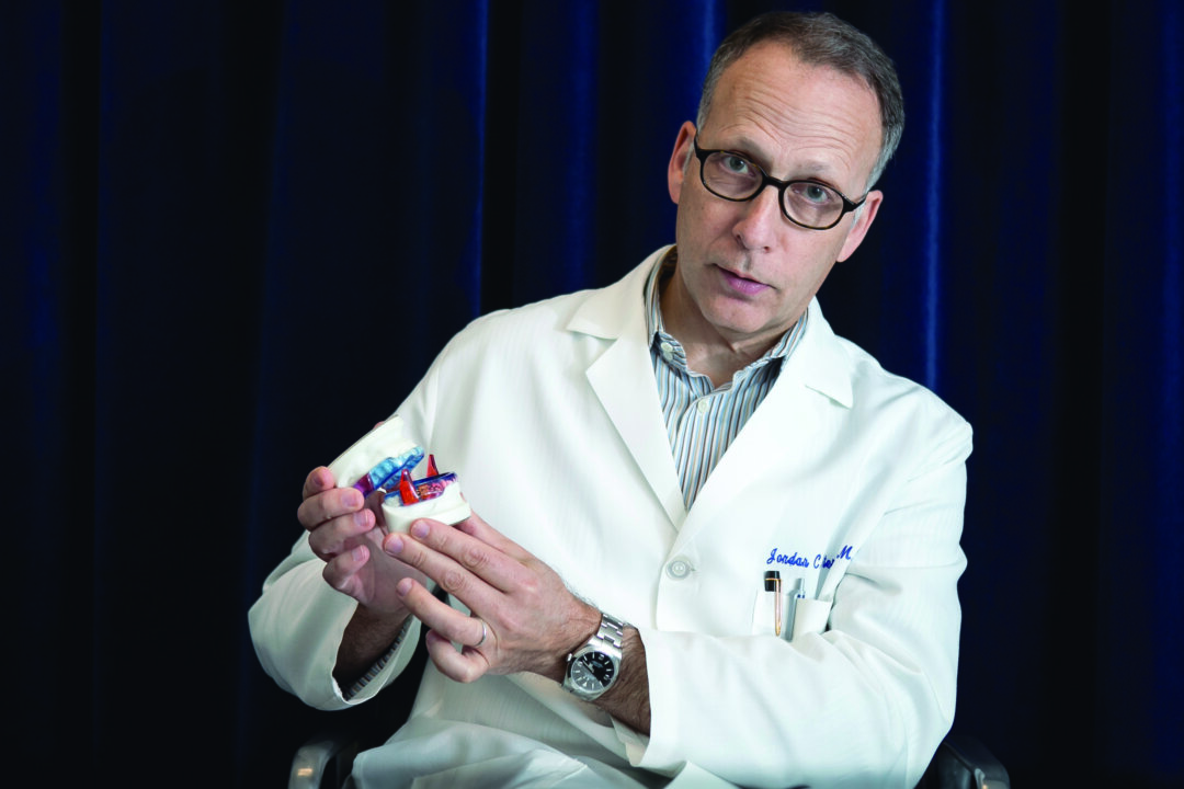 Dr. Jordan C. Stern holds an oral appliance used for treating sleep apnea at the blueSleep center in Manhattan, May 6. Sleep apnea affects about one-third of Americans, yet it’s still not standard medical practice to test for it, Dr. Stern said. (Epoch Times International)