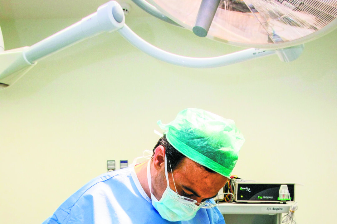 A Lebanese plastic surgeon performs plastic surgery on the stomach of a patient at his clinic in Rabyeh, northeast of Beirut, June 2009. Plastic surgery often requires follow-up care, which can add greatly to the costs for people to choose to have procedures done overseas. (Anwar Amro/AFP/Getty Images)