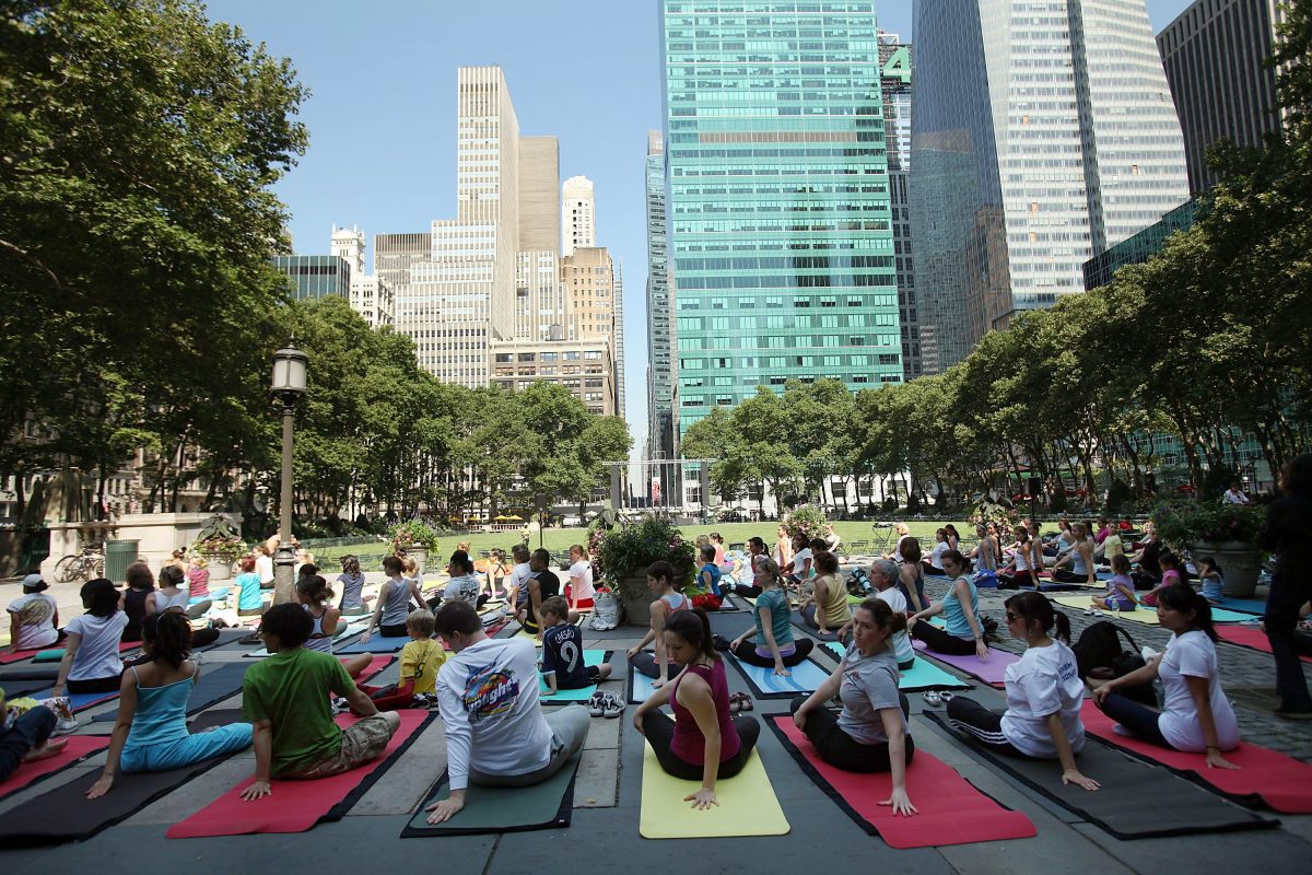 People participate in a free outdoor yoga class in Bryant Park on June 30, 2009, in New York City. After weeks of unseasonably wet weather, New York and New England have been experiencing dry and warm days, which have brought about a flurry of activity in area parks and recreation areas. (Photo by Spencer Platt/Getty Images)