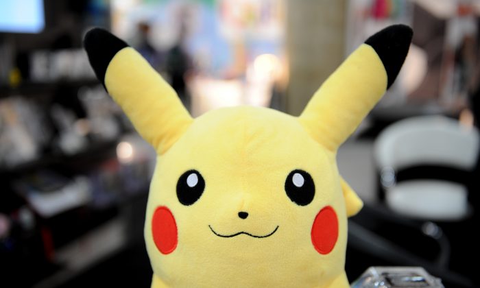 An article saying scientists are questioning the “existence of Pokemon” after a “live Pikachu” was caught in Africa is fake.  (STAN HONDA/AFP/Getty Images)