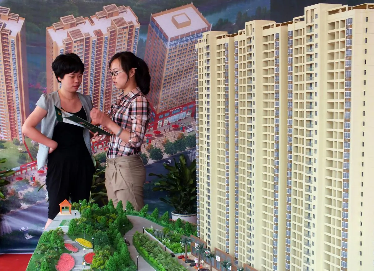 A Chinese homebuyer makes inquiries about a new apartment project on display at a real estate fair in Yichang, in central China’s Hubei Province on May 18, 2012. (AFP/AFP/Getty Images) 