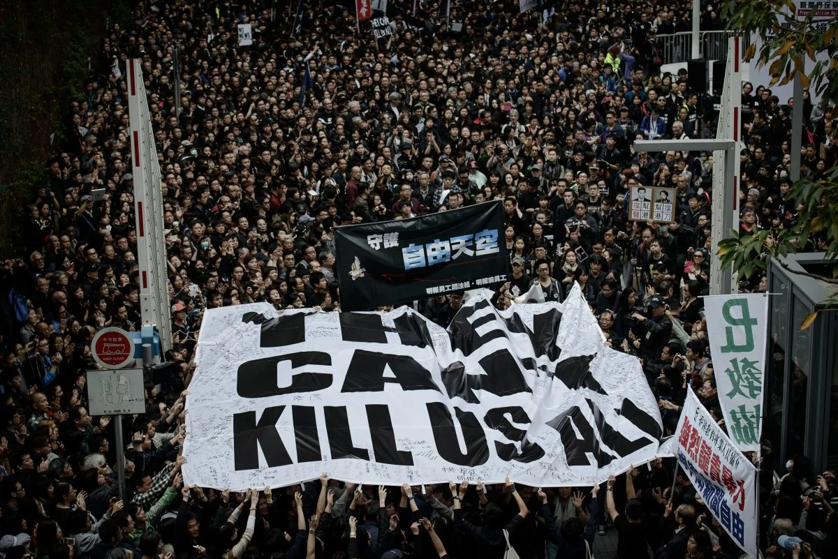 Protesters display a large banner during a rally to support press freedom in Hong Kong on March 2. The rally was staged following a violent attack on the former editor of a local liberal newspaper. (Philippe Lopez/AFP/Getty Images)