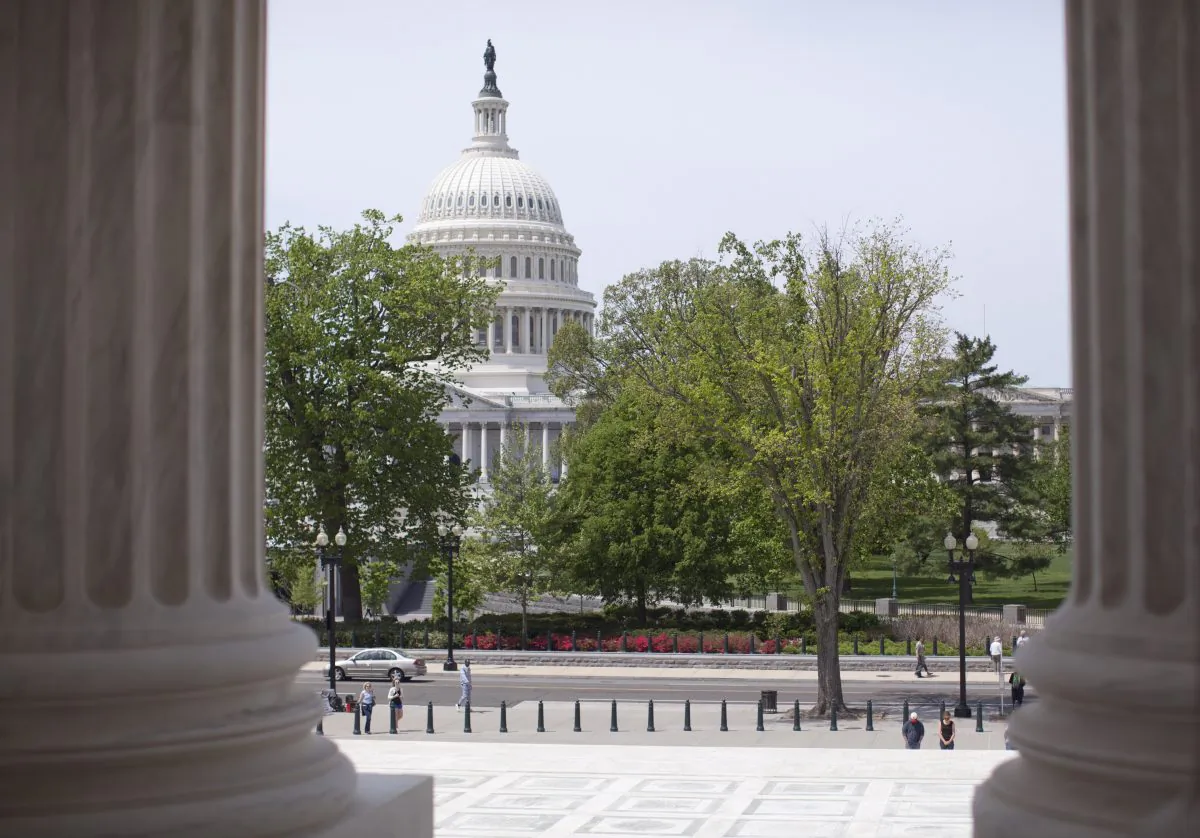 The U.S. Capitol building seen through the columns on the steps of the Supreme Court in Washington, D.C., on May 5, 2014. (AP Photo/Carolyn Kaster)