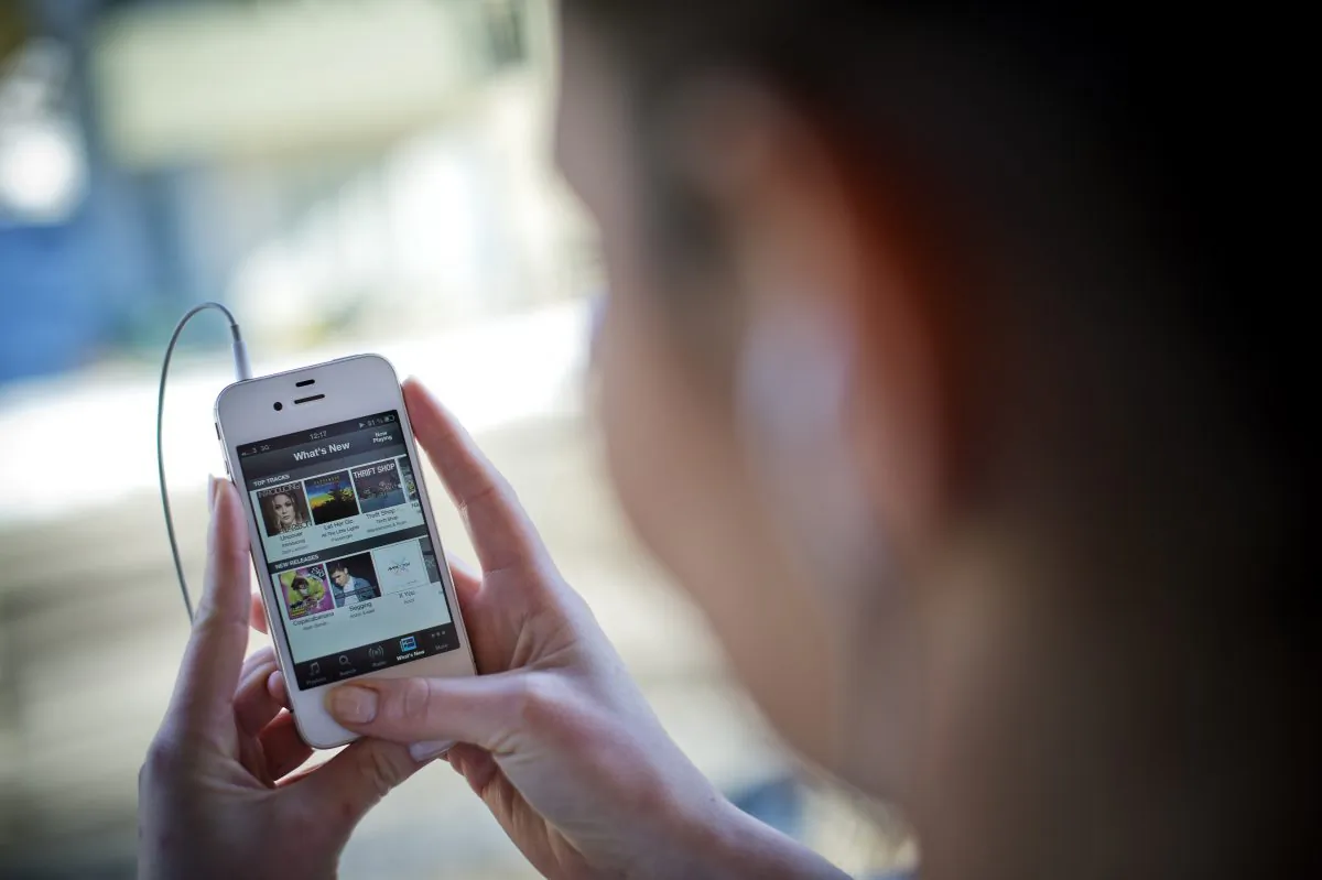 A woman uses her iPhone on March 7, 2013 in Stockholm, Sweden. Videos such as television shows and movies are increasingly viewed on mobile, allowing advertisers a new vehicle to communicate their messages. (Jonathan Nackstrand/AFP/Getty Images)