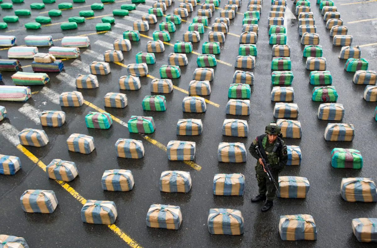 A Colombian member of a police anti-drugs unit stands guard next to marijuana packages displayed to the press, on March 26, 2013, in Cali, department of Valle del Cauca, Colombia. Police seized 7.7 tons of marijuana during the operation 'Republica 39', carried out between the municipalities of Tulua and Buga, who belonged to the Revolutionary Armed Forces of Colombia (FARC) guerrillas. The Director General of the National Police of Colombia, General Jose Roberto Leon Riano, said that 80 tons of marijuana and 36 tons of cocaine have been seized so far this year. (Luis Robayo/AFP/Getty Images)