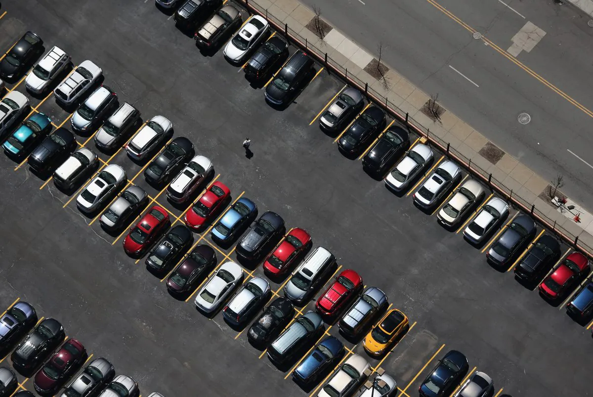 A man walks through a parking lot on June 4, 2013 in Buffalo, New York, near the U.S.-Canada border. The aerial view was seen from a helicopter flown by the U.S. Office of Air and Marine (OAM), which monitors and patrols the U.S.-Canada border. (John Moore/Getty Images)