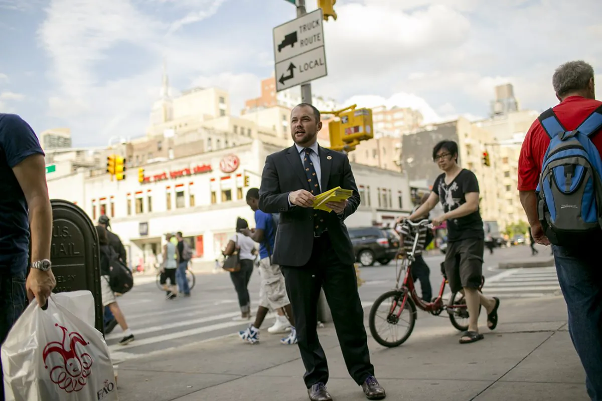 Council member Corey Johnson hands out fliers to raise awareness of paid sick leave in Chelsea on Wednesday. (William Alatriste/City Council)