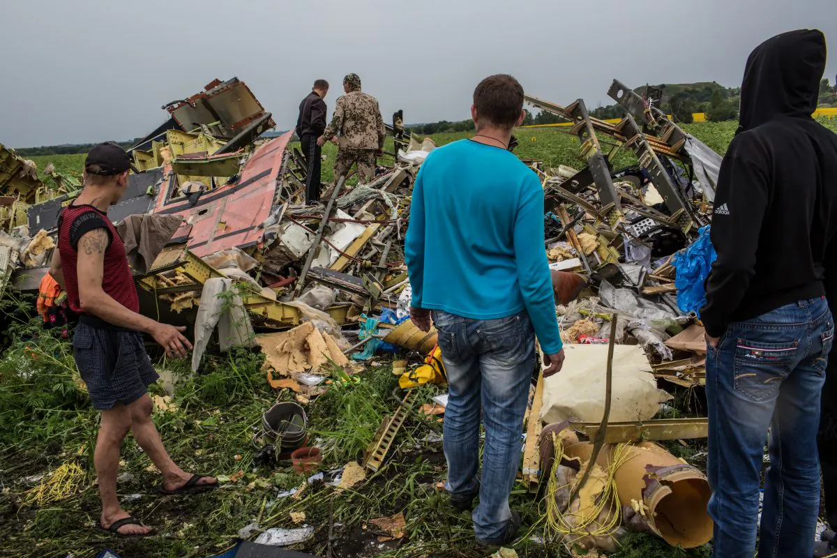 Men look at the wreckage of passenger plane Air Malaysia flight MH17 on July 18, 2014 in Grabovka, Ukraine. (Brendan Hoffman/Getty Images)