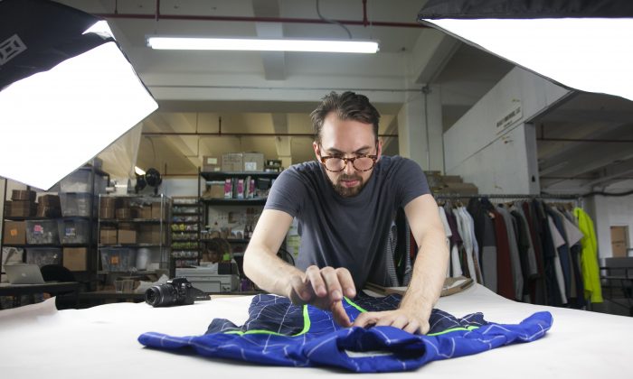 David Krause setting up a photo shoot for Alder New York at Pratt Institute's Brooklyn Fashion+Design Accelerator's temporary space at the Brooklyn Navy Yard, July 14, 2014. (Samira Bouaou/Epoch Times)