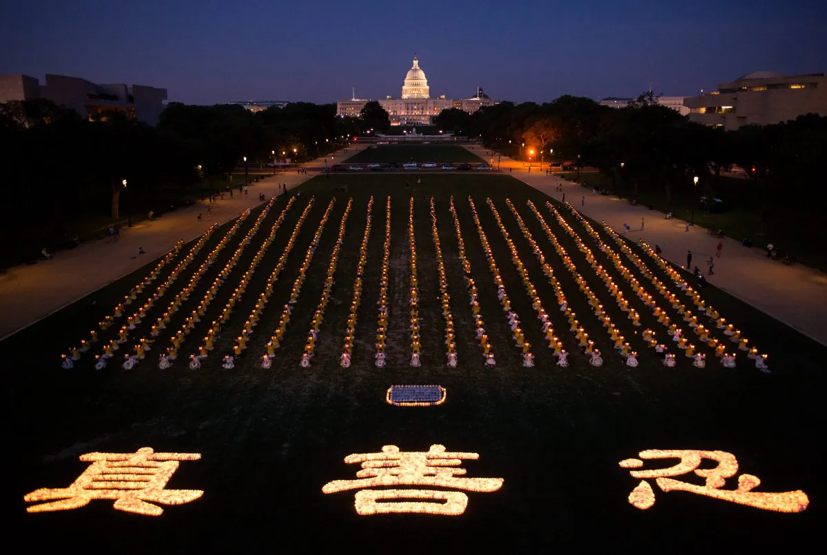 Falun Gong practitioners gather together to hold a candle light vigil in front of the U.S. Capitol, to commemorate the lives lost by the persecution, in Washington, D.C., on July 17, 2014. This year marks the 15 year of the persecution that started on July 20, 1999 in China. (Dai Bing/Epoch Times)