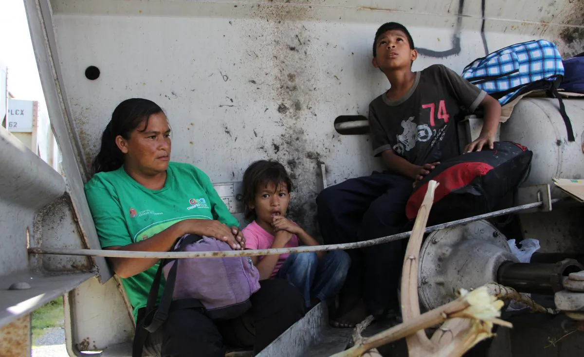 A Central American immigrant and her children sit inside the so-called La Bestia (The Beast) cargo train, in an attempt to reach the Mexico-US border, in Arriaga, Chiapas state, Mexico on July 16, 2014. (Elizabeth Ruiz/AFP/Getty Images)