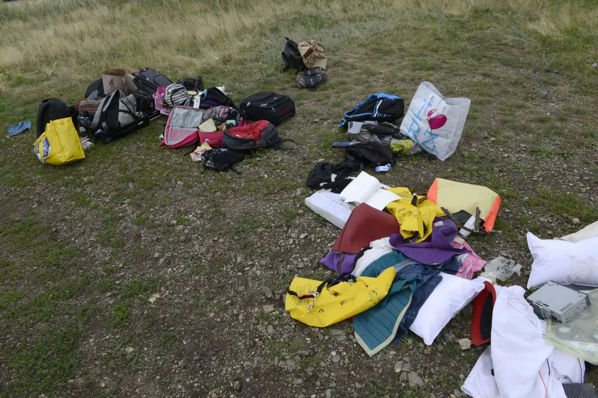 Passengers' belongings lie at the site of the crash of a Malaysia Airlines plane carrying 298 people from Amsterdam to Kuala Lumpur in Grabove, in rebel-held east Ukraine, on July 19, 2014. Ukraine and pro-Russian insurgents agreed on July 19 to set up a security zone around the crash site of a Malaysian jet whose downing in the rebel-held east has drawn global condemnation of the Kremlin. Outraged world leaders have demanded Russia's immediate cooperation in a prompt and independent probe into the shooting down on July 17 of flight MH17 with 298 people on board. (Alexander KHUDOTEPLY/AFP/Getty Images)