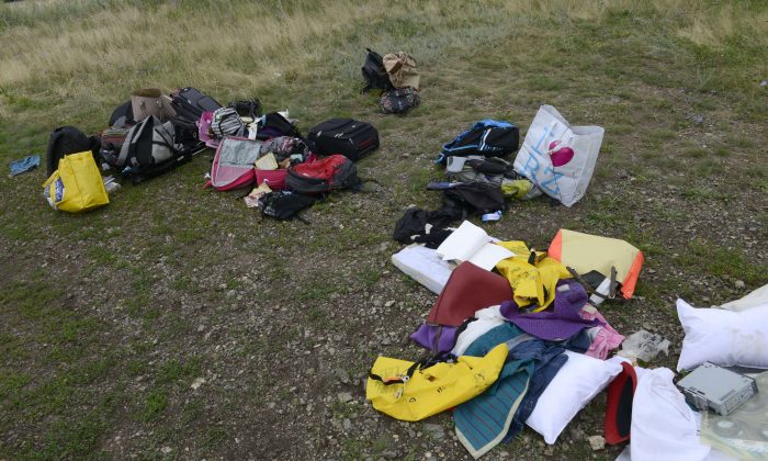 Passengers' belongings lie at the site of the crash of a Malaysia Airlines plane carrying 298 people from Amsterdam to Kuala Lumpur in Grabove, in rebel-held east Ukraine, on July 19, 2014. Ukraine and pro-Russian insurgents agreed on July 19 to set up a security zone around the crash site of a Malaysian jet whose downing in the rebel-held east has drawn global condemnation of the Kremlin. Outraged world leaders have demanded Russia's immediate cooperation in a prompt and independent probe into the shooting down on July 17 of flight MH17 with 298 people on board. (Alexander KHUDOTEPLY/AFP/Getty Images)