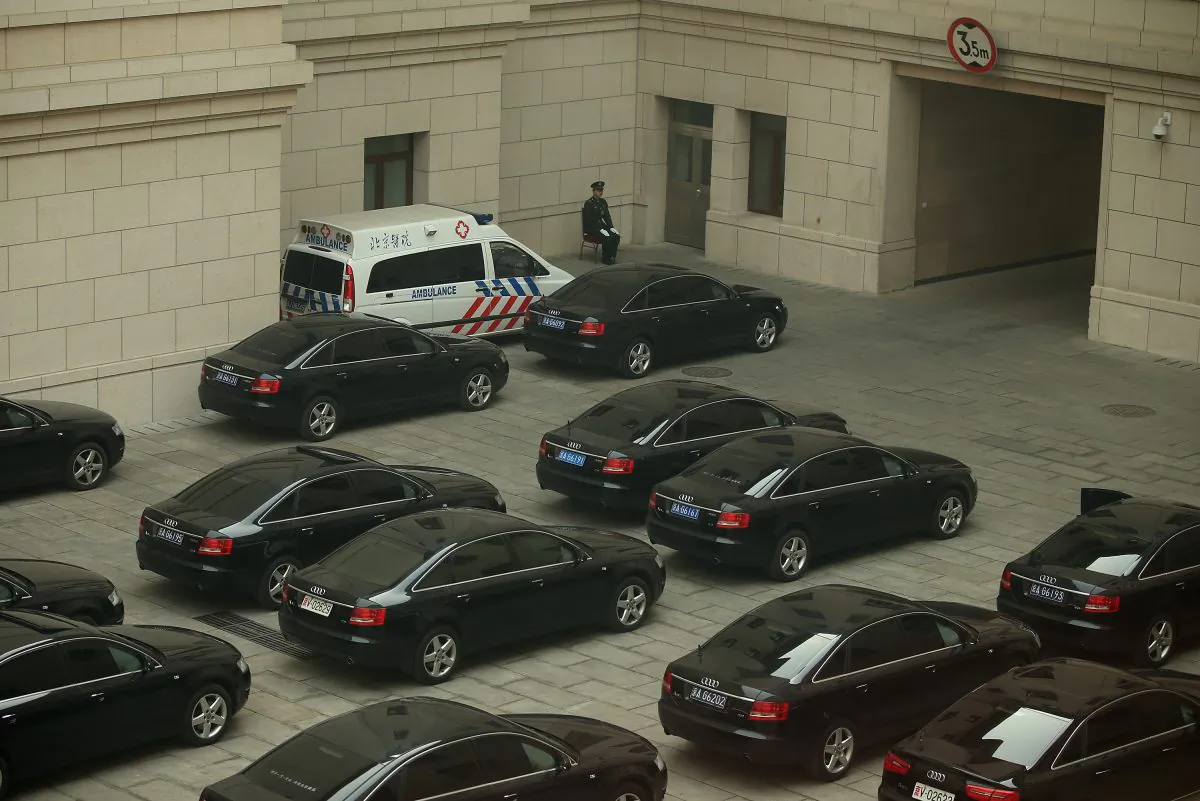 A soldier guards top leaders' cars inside the Great Hall of the People during a meeting of the National People's Congress on March 8, 2013 in Beijing, China. On July 16, China formally released a reform program for reducing officials' use of publicly provided cars. (Feng Li/Getty Images)