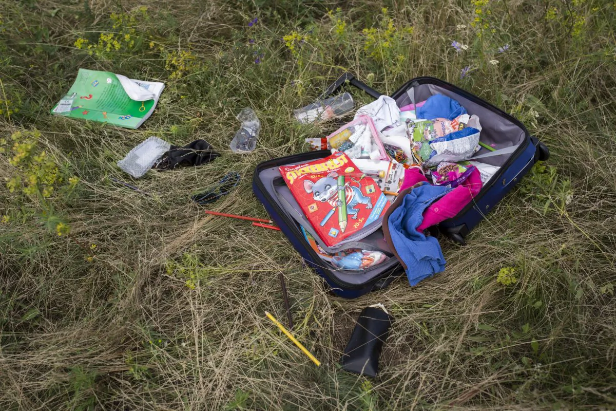 Luggage and personal belongings from Malaysia Airlines flight MH 17 lie in a field on July 20, 2014 in Grabovo, Ukraine. Malaysia Airlines flight MH17 was travelling from Amsterdam to Kuala Lumpur when it crashed killing all 298 on board including 80 children. The aircraft was allegedly shot down by a missile and investigations continue over the perpetrators of the attack. (Photo by Rob Stothard/Getty Images)