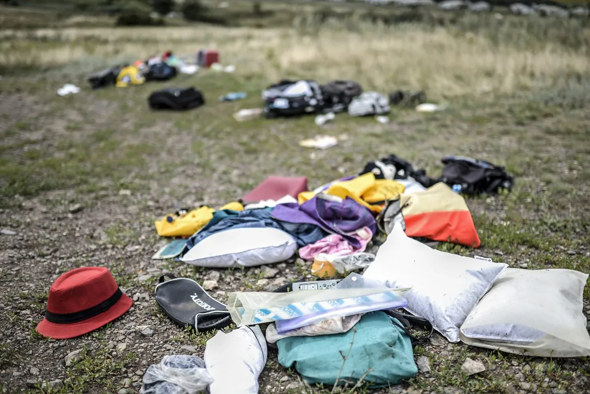 Belongings are scattered at the site of the crash of a Malaysia Airlines plane in Grabove, in rebel-held east Ukraine on July 20, 2014. The missile system used to shoot down a Malaysian airliner was handed to pro-Russian separatists in Ukraine by Moscow, the top US diplomat said Sunday. Outraged world leaders have demanded Russia's immediate cooperation in a prompt and independent probe into the shooting down on July 17 of flight MH17 with 298 people on board. (BULENT KILIC/AFP/Getty Images)
