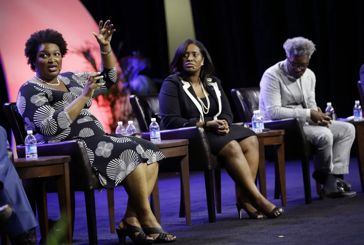 Stacy Abrams, (L), house minority leader for the Georgia General Assembly, on a panel with Jotaka Eaddy, (C), and Cornell Belcher, (R), on voter suppression during the NAACP annual convention July 22, 2014, in Las Vegas. (AP Photo/John Locher)