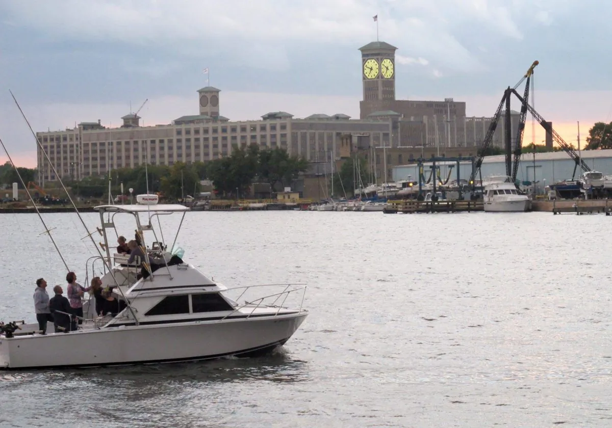 A fishing boat cruises on the Milwaukee River near Lake Michigan, an area designated for cleanup because of decades of toxic pollution, Sept. 12, 2013. Ottawa has announced new funding for four cleanup projects around the St. Clair River in Southwestern Ontario. (AP Photo/John Flesher)