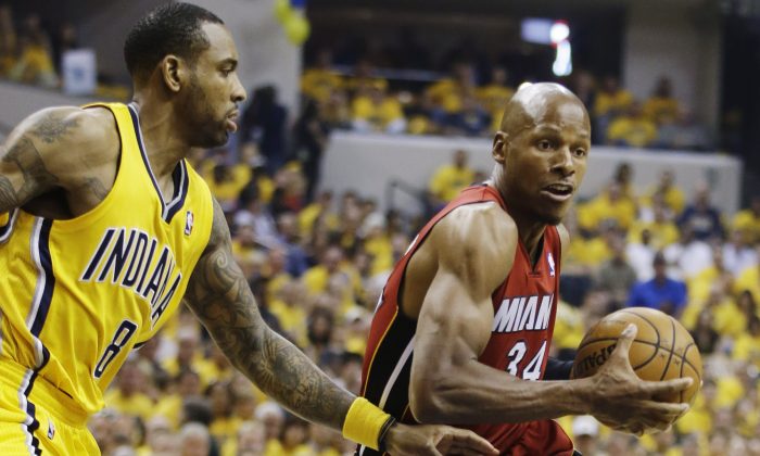 Miami Heat guard Ray Allen (34) drives around Indiana Pacers guard Rasual Butler (8) during the first half of Game 1 of the Eastern Conference finals NBA basketball playoff series in Indianapolis on May 18, 2014.  (AP Photo/Darron Cummings)