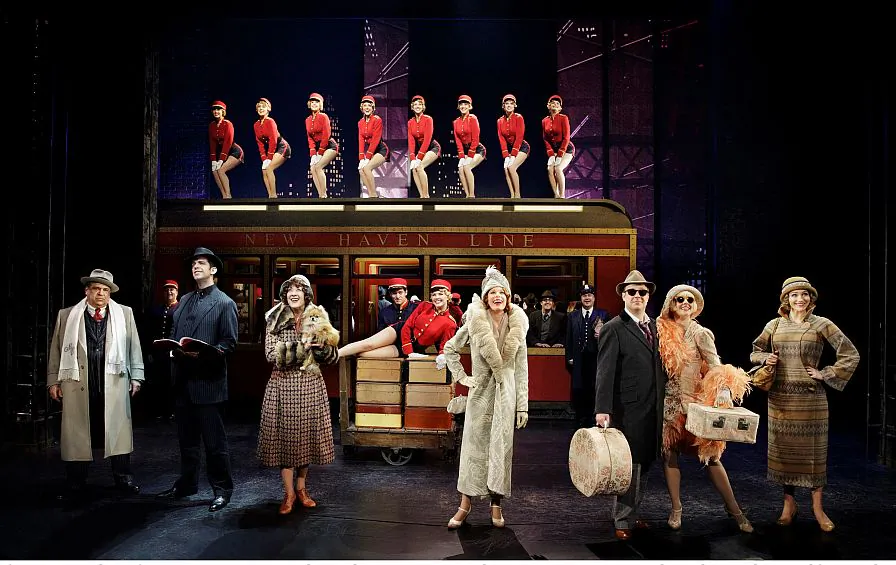 The cast of “Bullets Over Broadway,” in which gangsters and Broadway stars cavort. (L–R in foreground) Gangster Nick Valenti (Vincent Pastore), his goon-turned-ghostwriter Cheech (Nick Cordero), actress in the show Eden Brent (Karen Ziemba), the aging diva Helen Sinclair (Marin Mazzie), the leading man Warner Purcell (Brooks Ashmanskas), the gangster’s less-than-talented girlfriend Olive (Heléne Yorke), and the playwright’s girlfriend Ellen (Betsy Wolfe). (Paul Kolnik)