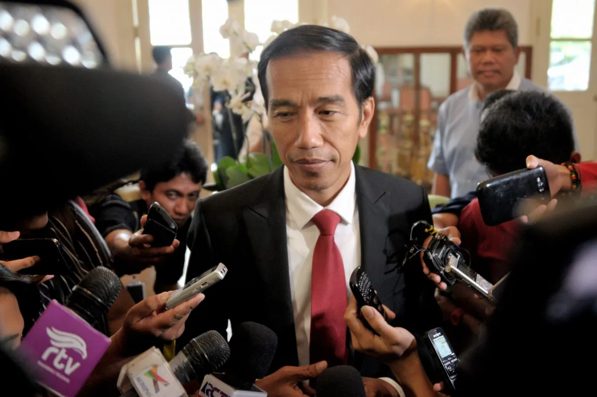Indonesian president elect Joko Widodo (C) answers questions from the media in Jakarta on July 23, 2014 as Widodo returns to work after the General Elections Commission declared him the winner of the presidential elections. The ex-general who lost Indonesia's presidential election to Joko Widodo will challenge the result in court, his campaign team said, a move that could spell weeks of uncertainty for the country. (Bay Ismoyo/AFP/Getty Images)